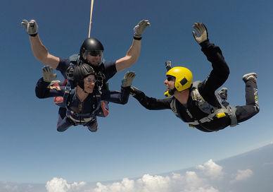 An image of two people skydiling, Tandem Skydive. Army Parachute Association