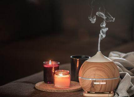 An image of a wooden diffuse diffuser with a candle and a tea light, Absolute Spa Ritual for Her. Aurora Wellbeing Spa
