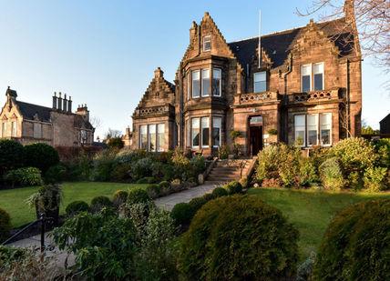 An image of a large house in the middle of a garden, Edinburgh, Scotland. Ba'Bar at The Dunstane Houses
