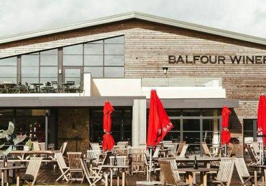 An image of a restaurant with tables and chairs, Wine and Dine Experience. Balfour Winery