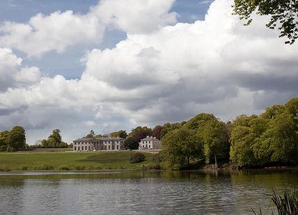 An image of a lake with a house in the background, Escape to Ireland's Grandest Country House. Ballyfin