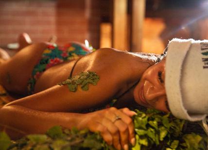 An image of a woman laying down in the grass, Exclusive Russian Spa Experience. Banya No.1