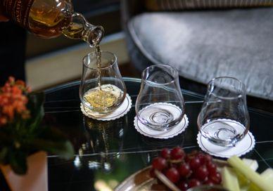 An image of a person pouring wine into glasses, Discover Whisky Masterclass. The Bar At The Athenaeum