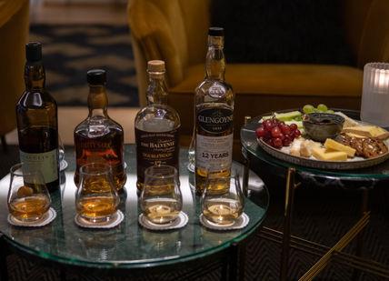 An image of a table with drinks and food, Essential Scottish Whisky Tasting. The Bar At The Athenaeum
