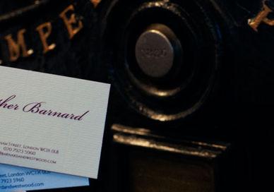 An image of a person holding a business card, Create a Bespoke Stationery Set. Barnard & Westwood