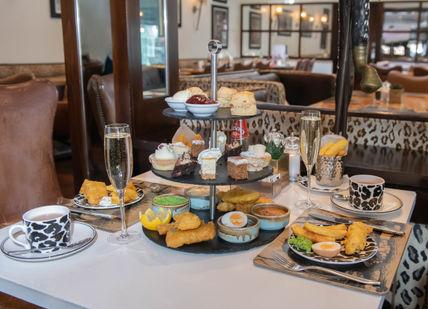 An image of a table with a tray of food, Afternoon tea. Bbar London