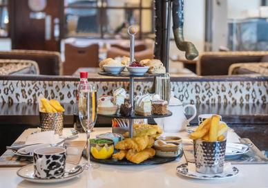 An image of a table with a tray of food, Afternoon tea. Bbar London