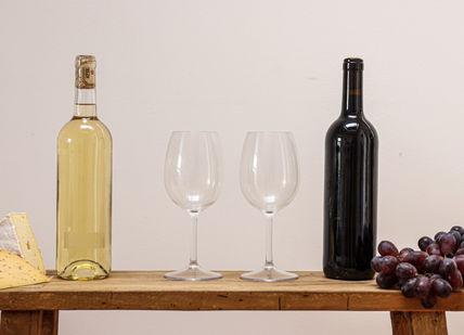 An image of a wine bottle and two glasses, Wine and Cheese Tasting. Birmingham Wine School