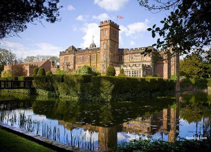 An image of a castle with a pond in front, Wine, Lunch and Champagne. Birmingham Wine School
