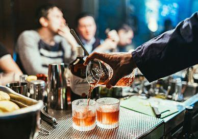 An image of a person pouring a drink, Ultra-Premium Rum Tasting. Black Parrot
