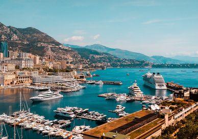 An image of a harbor with boats docked in it, Private return transfer to yacht cruise for 5-star Monaco Break. Blacklane