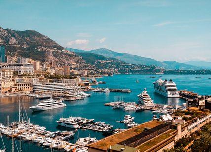 An image of a harbor with boats docked in it, Private return transfer to yacht cruise for 5-star Monaco Break. Blacklane