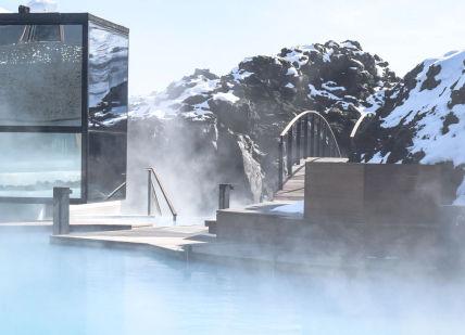 An image of a hot pool in the snow, Retreat Spa package, plus LAVA Restaurant's Tasting Menu and a 30-minute "Relaxing Massage. Blue Lagoon