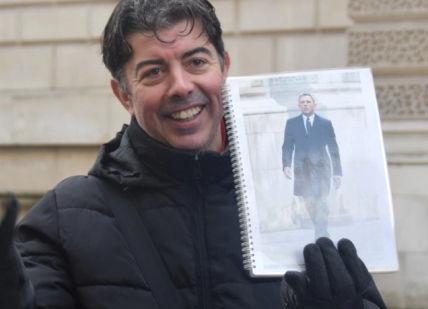 An image of a man holding a magazine, Private James Bond Walking Tour of London. Brit Movie Tours