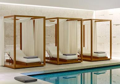 An image of a pool with a canopy bed, Bulgari Break' Spa Programme. Bulgari Hotel London