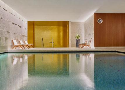 An image of a pool with a clock, Bulgari Break' Spa Programme. Bulgari Hotel London