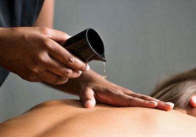 An image of a woman getting a massage, Bulgari Break' Spa Programme. Bulgari Hotel London