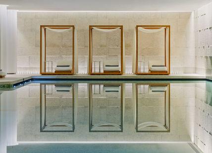 An image of a swimming pool with a mirror, Mind and Body Indulgence Spa Day. Bulgari Hotel London