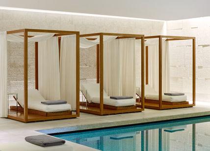 An image of a pool with a canopy bed, Mind and Body Indulgence Spa Day. Bulgari Hotel London