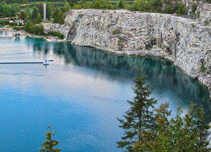 An image of a lake with a boat in it, Experience the Thrill of Canada's Highest Bungee Jump. Bungee Canada