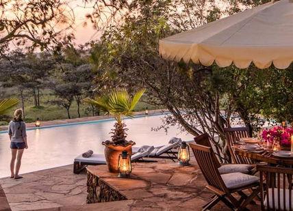An image of a patio with a table and chairs, Luxury Maasai Mara Kenyan Safari. Campi ya Kanzi