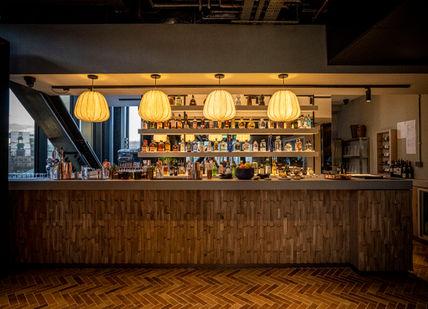 An image of a bar with a wooden counter, Cavo Restaurant. Cavo Restaurant