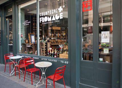 An image of a restaurant with red chairs, Covent Garden, London. Champagne + Fromage