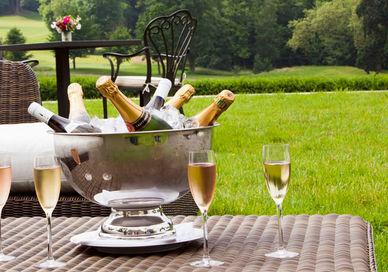 An image of a patio setting with a drink and a wine glass, Exclusive Hire of Château Bouffémont. Chateau Bouffemont