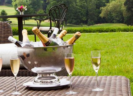 An image of a patio setting with a drink and a wine glass, Exclusive Hire of Château Bouffémont. Chateau Bouffemont