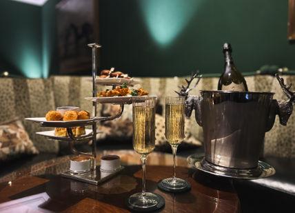 An image of glasses of champagne and food