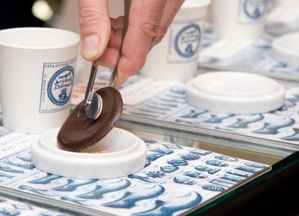 An image of a person dipping chocolate into a cup, Private Chelsea Sweet Treats Adventure. Chocolate Ecstasy Tours