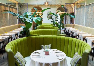 An image of a restaurant setting with green chairs, Cigalon. Cigalon