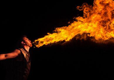 An image of a man with a fire stick, Private Circus Entertainment Masterclass. Circus Stardust