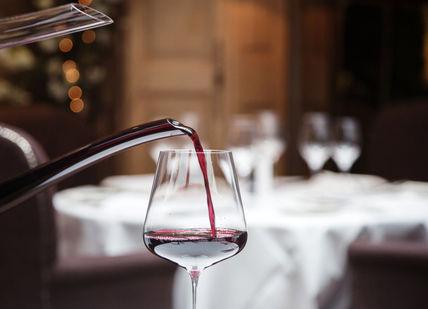 An image of a wine being poured into a glass, Five-course tasting menu. Clos Maggiore
