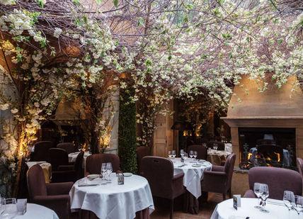 An image of a restaurant setting with tables and chairs, Three-course Lunch. Clos Maggiore