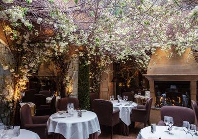 An image of a restaurant setting with tables and chairs, Covent Garden, London. Clos Maggiore