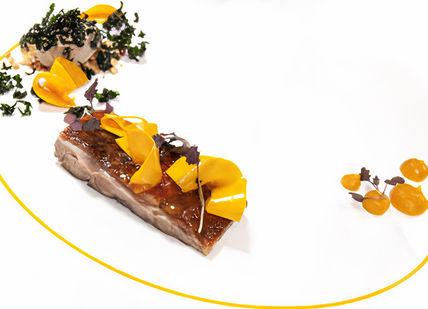 An image of a plate of food with a yellow line, Eight-Course Tasting Menu. Club Gascon