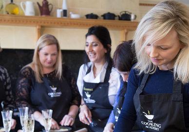 An image of a woman cooking in a kitchen, Private Half-Day Cookery Course. The Cooking Academy