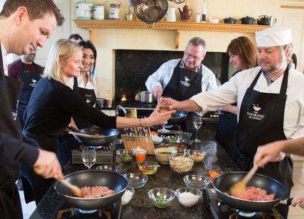 An image of a group of people cooking, The Cooking Academy. The Cooking Academy