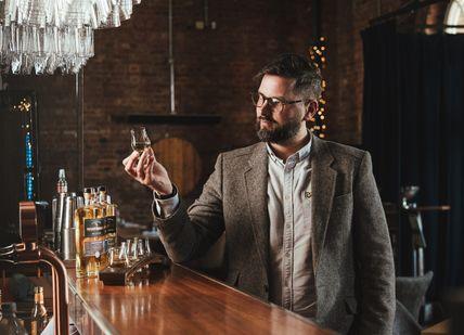 An image of person doing a whisky tatsing