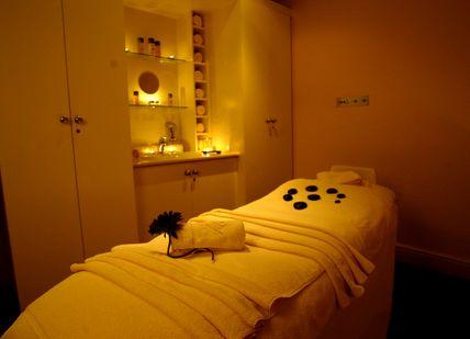 An image of a massage room with towels and candles, Overnight Spa Break. Danesfield House
