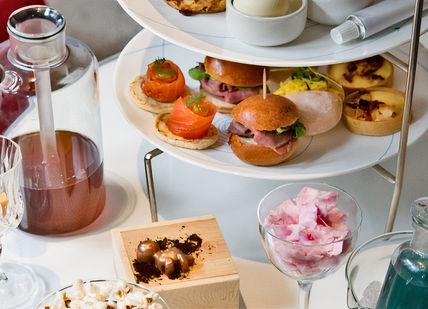 An image of a table with a variety of food, Science-Inspired Cocktail Afternoon Tea. The Drawing Room at The Ampersand Hotel
