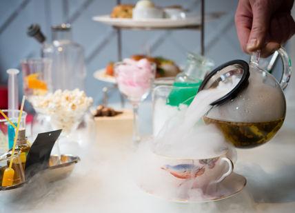 An image of a person pouring tea into a cup, Science-Inspired Cocktail Afternoon Tea. The Drawing Room at The Ampersand Hotel