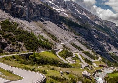 An image of a mountain road with a car driving down it, Follow Top Gear's Stelvio Pass Adventure. Edel & Stark