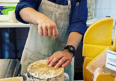 An image of a man making cheese, Edinburgh New Town and Stockbridge Food Tour. Edinburgh Food Safari - Stockbridge