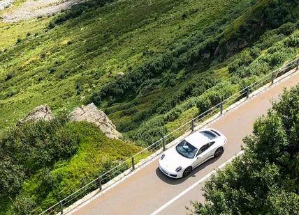 An image of a car driving down a mountain road, Swiss Alps Self-Drive Tour. Epikdrives