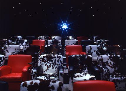 An image of a movie theater with red chairs, The Soho Hotel. Firmdale Hotels