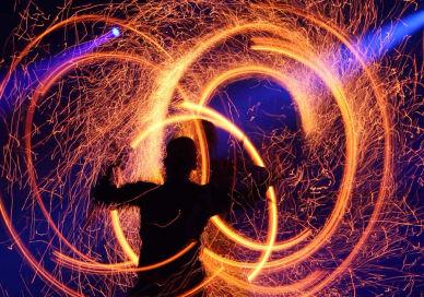 An image of a person with fire in the air, Private Fire Spectacle Workshop. Flame Oz