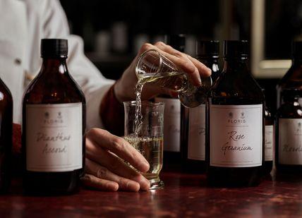 An image of a person pouring wine into a glass, Create Your Own Fully-Bespoke Perfume. Floris