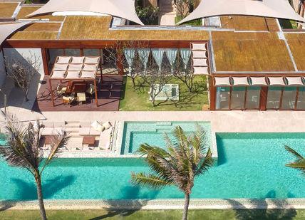 An image of a house with a swimming pool, Four-night Wellness Break. Fusion Resorts